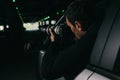 rear view of male paparazzi spying by camera with object glass from his