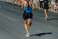 rear view male runner running city marathon