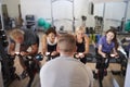 Rear View Of Male Trainer Taking Spin Class In Gym Royalty Free Stock Photo