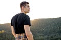 Rear view on male traveller looking at side in contemplation, at sunset Royalty Free Stock Photo