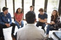 Rear View Of Male Tutor Leading Discussion Group Amongst High School Pupils Royalty Free Stock Photo