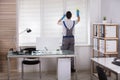 Male Worker Cleaning Window Blinds With Sponge