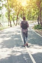 Rear view of man with backpack walking on the side road, Time go