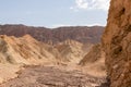 Rear view of man hiking in golden Canyon with scenic view of colorful geology of multi hued Amargosa Chaos rock formations