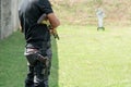 Rear view Man holding shotgun and carry handgun on the calf at front of Target in Shooting Range. Men Practicing Fire Pistol Royalty Free Stock Photo