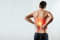 Rear view, the man holds his hands behind his back, pain in the back, pain in the spine, highlighted in red. Royalty Free Stock Photo