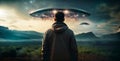 Rear view of a man looking at two huge bright UFOs in the sky Royalty Free Stock Photo