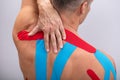Rear View Of Man With Physio Tape