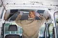 Man working on insulation inside his camper van