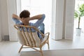 Rear view man relaxing on chair daydreams looks into distance Royalty Free Stock Photo