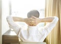 Rear view of man relaxing on chair at home Royalty Free Stock Photo