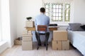 Rear View Of Man Running Business From Home Dispatching Goods