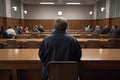 Rear view of a man sitting in front of a group of people in the conference hall, A court attorney lawyer full rear view inside Royalty Free Stock Photo