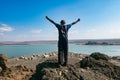 Rear view of a tourist against the background of El Molo village at the shores of Lake Turkana in Loiyangalani, Kenya Royalty Free Stock Photo