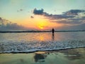 Rear View Of Man Standing In Sea Against Sky During Sunset Royalty Free Stock Photo