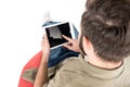 rear view of man using digital tablet while sitting on bean bag chair, Royalty Free Stock Photo