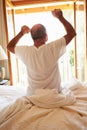 Rear View Of Man Waking Up In Bed In Morning Royalty Free Stock Photo