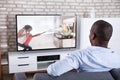 Rear View Of A Man Watching Television Royalty Free Stock Photo