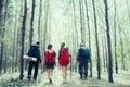 Rear view of man and woman hikers trekking a rocky path in forest. Hiker couple exploring nature walking through the woods. Backpa Royalty Free Stock Photo