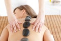 Rear view of a massage with hot stone Royalty Free Stock Photo
