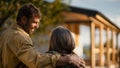 Rear view of mature couple looking at their new house under construction, planning future and dreaming. Royalty Free Stock Photo