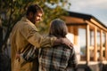 Rear view of mature couple looking at their new house under construction, planning future and dreaming. Royalty Free Stock Photo