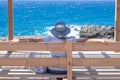 Rear view of mature woman dressed in blue admiring the sea looking at horizon over water. Mature lady enjoying relaxation and