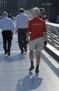 People walking across Millennium Bridge London UK 2003