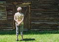 Rear view of a middle aged Caucasian woman standing in front of a a large barn door Royalty Free Stock Photo