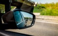 Rear view mirror of a car with multiple vehichles in the jam