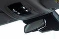 Rear view mirror closeup in nodern car. Royalty Free Stock Photo