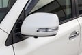Rear-view mirror or door mirror closed for safety at car park, Side mirror of gray car black tinted glass Royalty Free Stock Photo