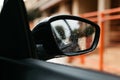 Rear view mirror seen through the glass. Wet car window. Close up rain drop. Car view see the mirror Royalty Free Stock Photo