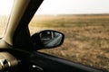 Rear view mirror seen through the glass. Wet car window. Close up rain drop. Car view see the mirror Royalty Free Stock Photo