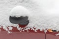 Rear-view mirror and side part of parked snowbound car