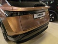 Rear view of modern japanese compact crossover battery electric SUV car Nissan Ariya