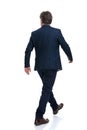 Rear view of a motivated businessman walking