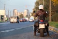 Rear view at motorcyclist with bike standing on urban road, female rider is ready to start movement in city Royalty Free Stock Photo