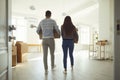 Rear view moving. Young couple family with boxes to move in a new house room. Royalty Free Stock Photo