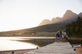 Rear View Of Multi Generation Family Standing On Jetty By Lake