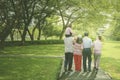 Multi generation family walks in the park Royalty Free Stock Photo