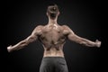 Rear view of muscular man with his arms stretched out Royalty Free Stock Photo