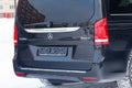 Rear view of new an expensive Mercedes Benz V-class minivan bumper and trunk of a car, a long black limousine, model outdoors, Royalty Free Stock Photo