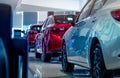 Rear view of new luxury red and white car parked in modern show room. Selective focus on white shiny car. Car dealership concept. Royalty Free Stock Photo