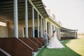 Rear view, newlyweds are walking along the green field of the golf club on a wedding day. The bride and groom in wedding Royalty Free Stock Photo