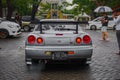 Rear view of Nissan Skyline GT-R R34 with its iconic round taillights and spoiler