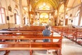 Rear view of the old man kneeing and praying in Santa Cruz Church or Kudi Chin, one of the many old Catholic church in Bangkok. W