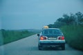 Rear view of one taxi on the street in Congo at dusk Royalty Free Stock Photo