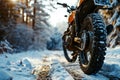 Rear view of an orange motorcycle standing in a rut on a snowy forest path on a winter cloudy day Royalty Free Stock Photo