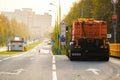 Rear view of an orange multifunctional heavy duty truck for cleaning an asphalt street Royalty Free Stock Photo